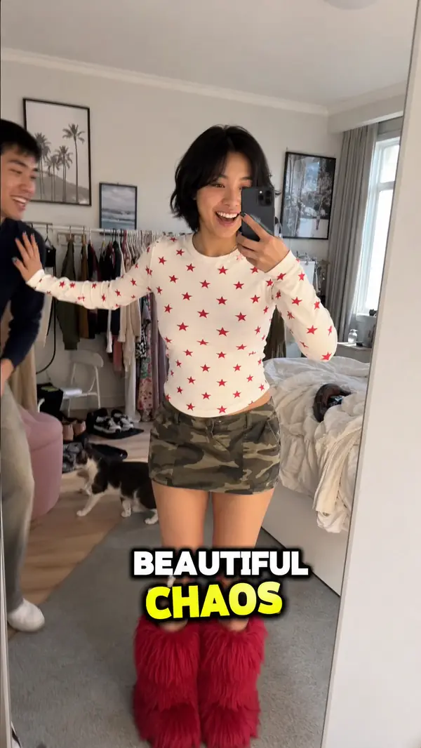 Fashion mirror-selfie video with bold outlined captions reading "BEAUTIFUL CHAOS"